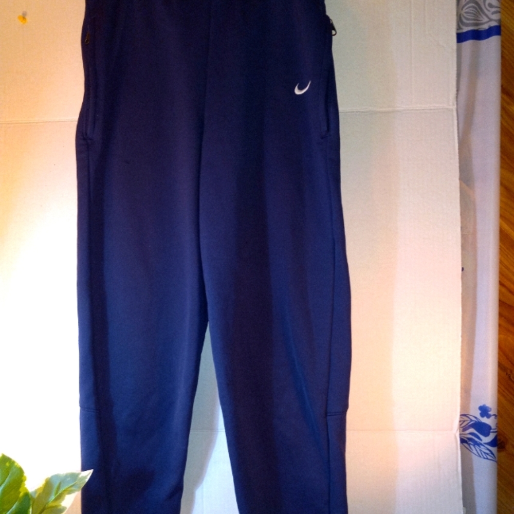 Nike joggers, with ankle zips and zippered pockets.